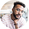 Headshot of a man with a beard and glasses